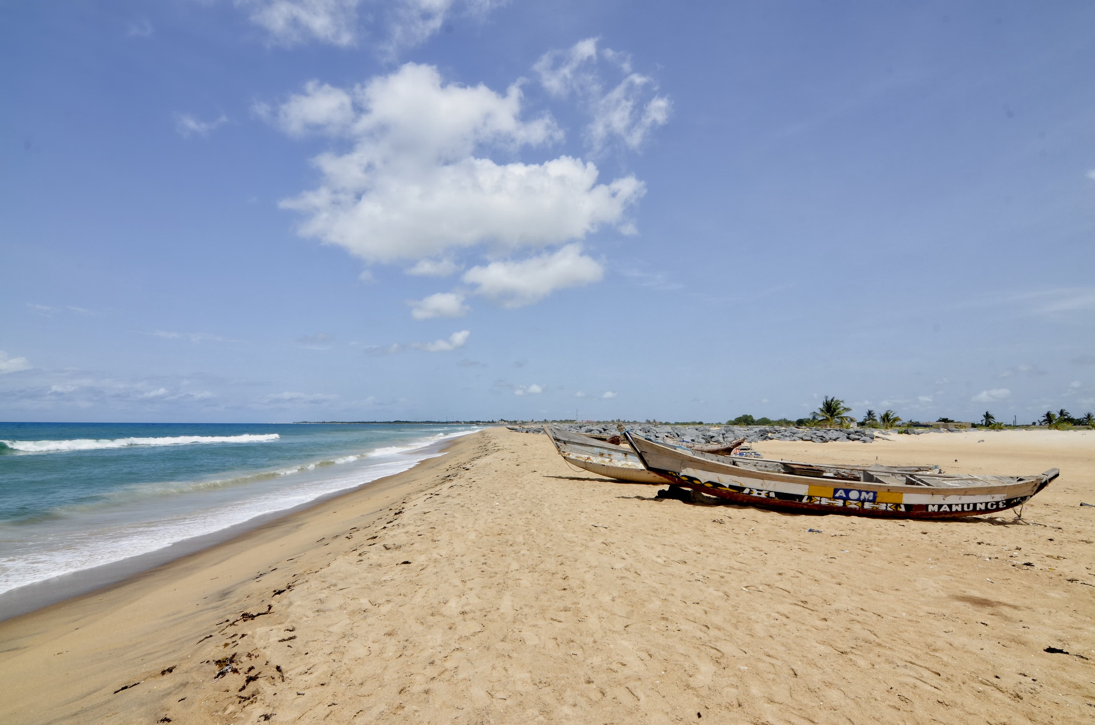 A fisherman skillfully gathering fish in Keta, Volta Region, Ghana, during the day.